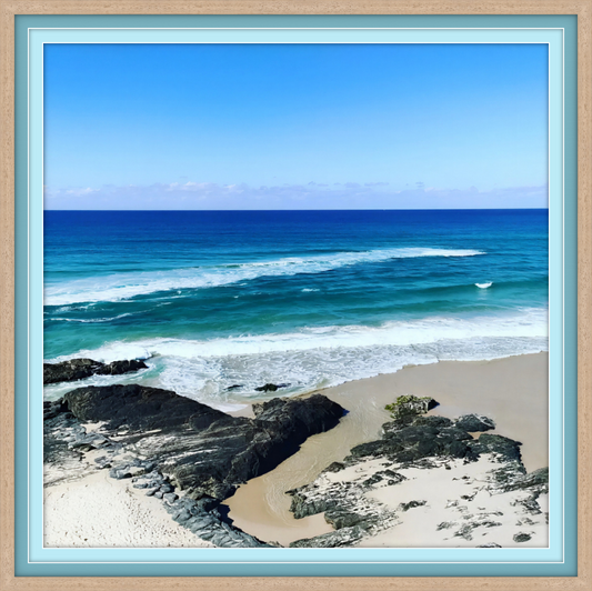 Beach scene with blue ocean and clear sky, framed with a light blue border.