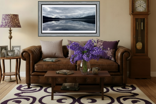 Living room with brown sofa, coffee table, and decorative items.